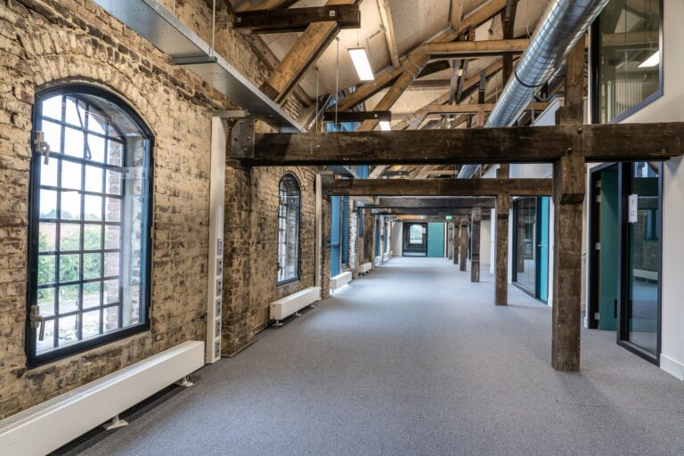 Intérieur rénové avec poutres apparentes en bois et plafond isolé